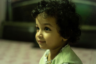 Close-up portrait of cute girl looking away