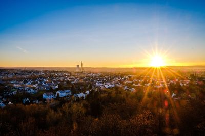 Aerial view of cityscape against sky during sunset