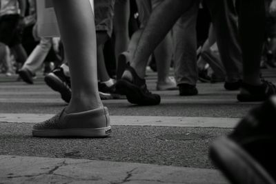 Low section of woman standing on tiled floor