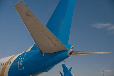 Low angle view of airplane flying against sky