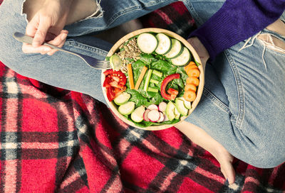 Low section of woman holding food