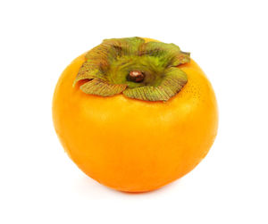 Close-up of orange fruit against white background