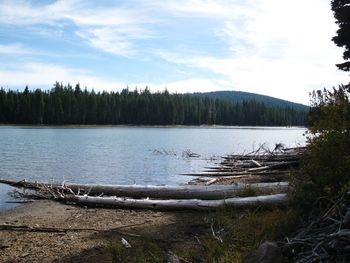 Scenic view of lake against cloudy sky