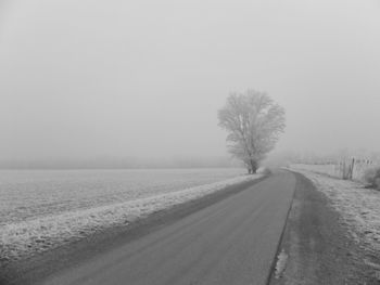 Scenic view of snow covered field against clear sky