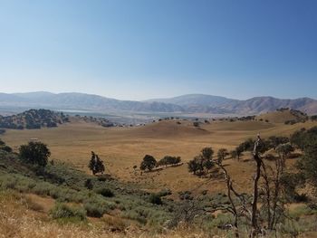 Scenic view of mountains against blue sky