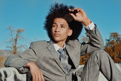 Portrait of young woman against blue sky