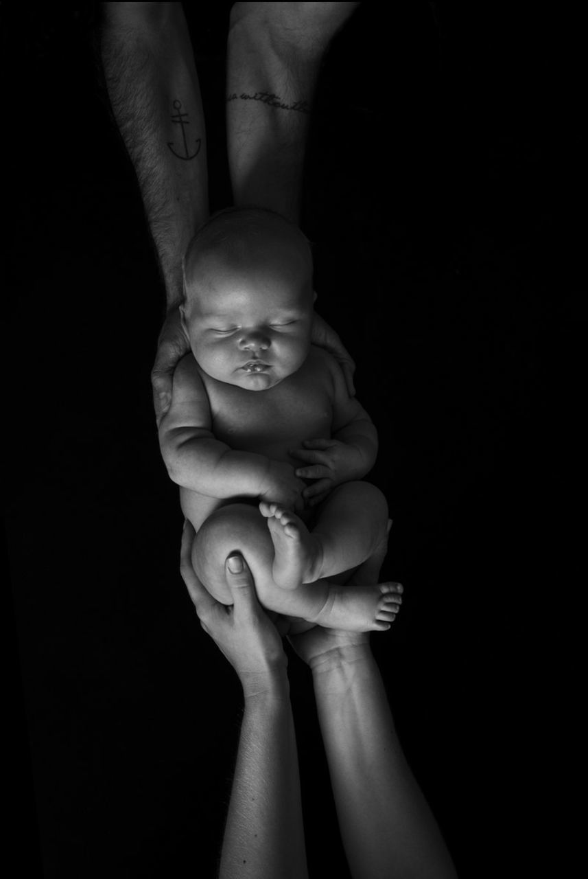 human hand, human body part, hand, baby, black background, young, studio shot, real people, child, indoors, holding, childhood, body part, people, babyhood, finger, human finger, two people, togetherness, care, human limb