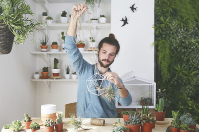 Plant collector preparing the pendant for an air plant