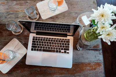 High angle view of white and laptop on table