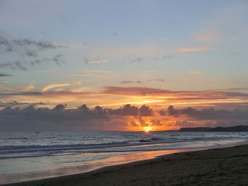 Scenic view of beach against sky during sunset