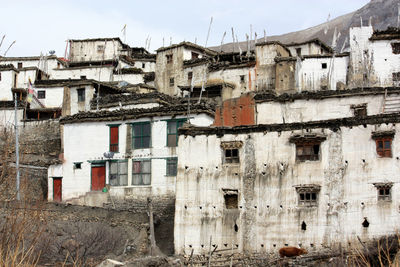 Low angle view of old buildings against sky in nepali village in lower mustang