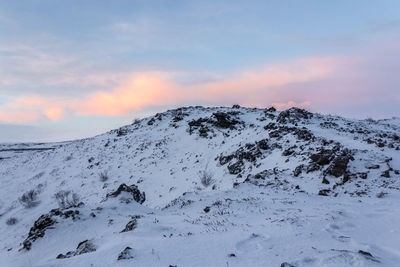 Scenic view of snow covered mountains against sky during sunset