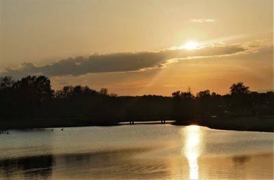 Scenic view of lake against sky during sunset