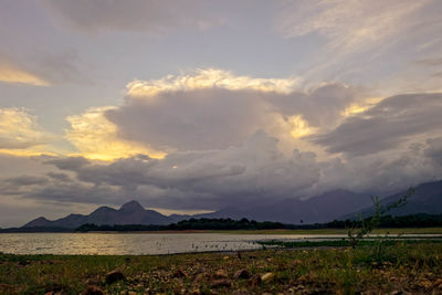 Scenic view of landscape against cloudy sky
