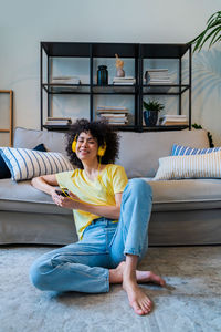 Smiling woman sitting at home