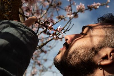 Close-up portrait of man against tree