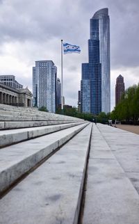 View of city buildings against cloudy sky