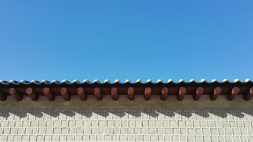 Low angle view of roof tiles against clear sky