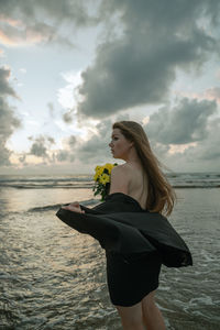 Portrait of young woman holding flower