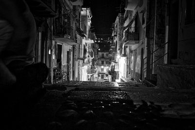 Street amidst buildings at night