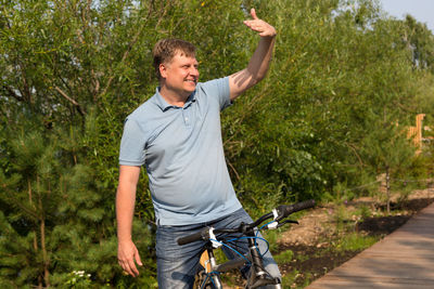 Young man riding bicycle on field