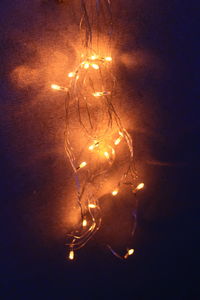 Close-up of illuminated light bulbs in the dark