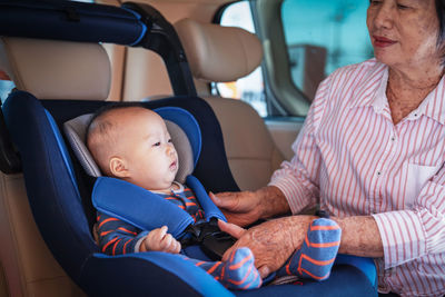 Rear view of people sitting in car