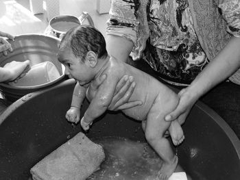 Close-up of hands on water