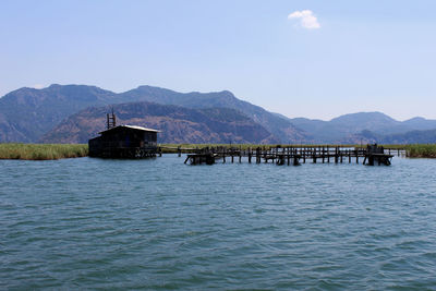 Pier over lake against sky