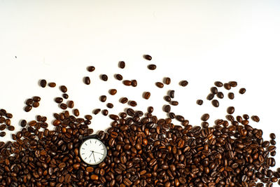 High angle view of coffee beans against white background