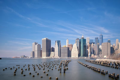 View of skyscrapers against cloudy sky