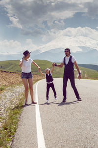 Fashionable family in hats walks along the road in nature at mount everest