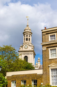 Low angle view of trees and building against sky