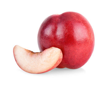 Close-up of red heart shape over white background