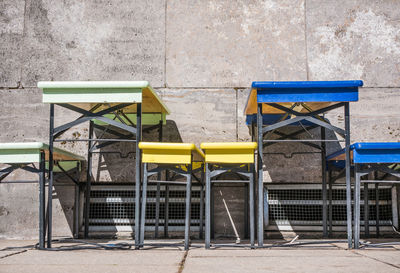 Empty chairs against wall