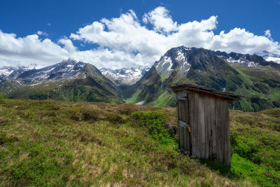 Restroom in the alps with a scenic view of mountains against sky