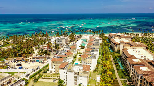 High angle view of townscape by sea against sky