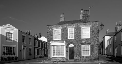 Street amidst buildings against sky in city