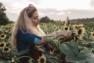 Young woman cutting plants