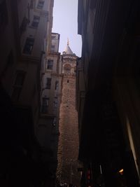 Low angle view of buildings in city at dusk