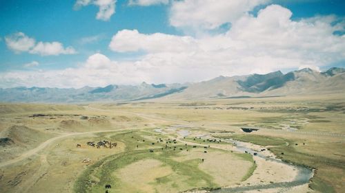 Scenic view of mountains against cloudy sky