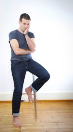 Young man standing on hardwood floor