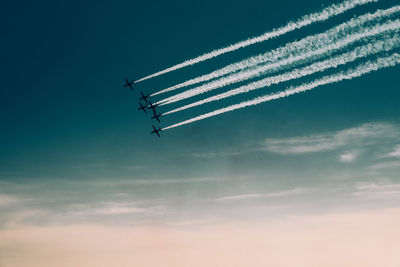 Low angle view of airplane flying against sky