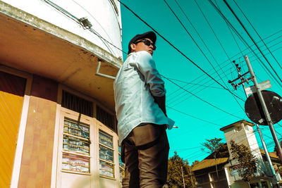 Low angle view of man standing against building