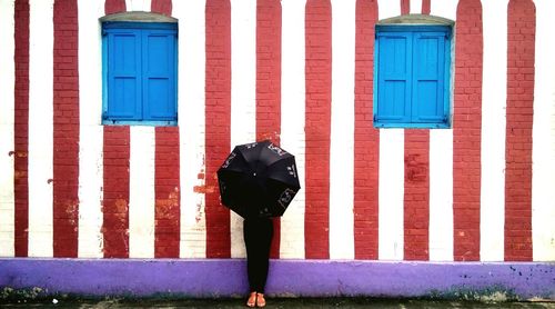 Full length of multi colored umbrella on building