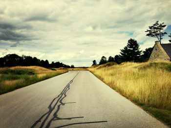 Empty road along trees