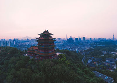 High angle view of buildings in city at sunset