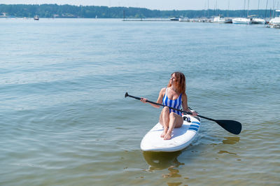 Woman sitting in sea