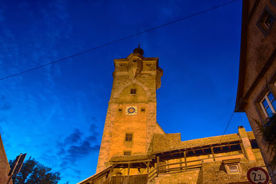 Low angle view of old building against blue sky