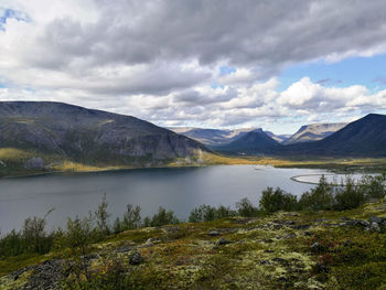 Scenic view of lake and mountains against sky